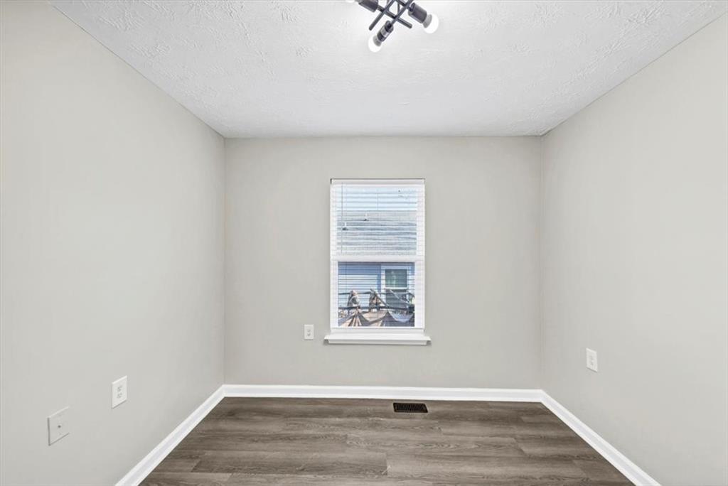 2478 Verbena Circle Northwest Atlanta, GA 30314 - Photo 20 of 42 a view of an empty room with wooden floor and a window