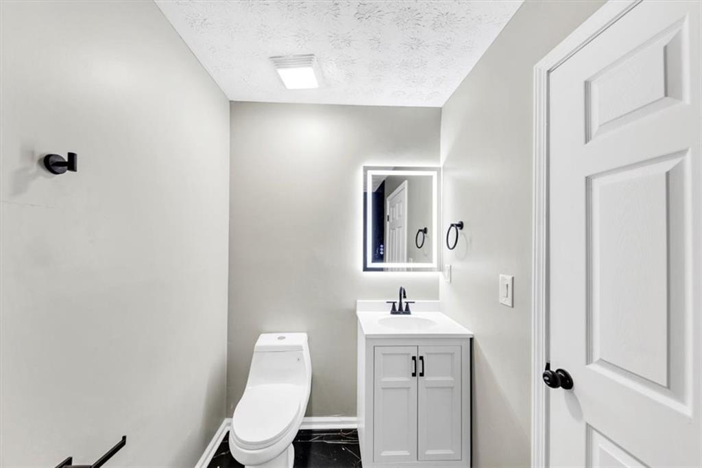 2478 Verbena Circle Northwest Atlanta, GA 30314 - Photo 23 of 42 a bathroom with a toilet sink and mirror