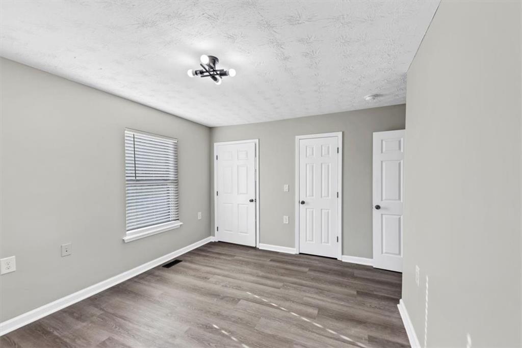 2478 Verbena Circle Northwest Atlanta, GA 30314 - Photo 26 of 42 a view of an empty room with wooden floor and a window