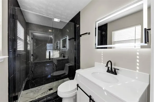 a bathroom with a sink toilet and shower