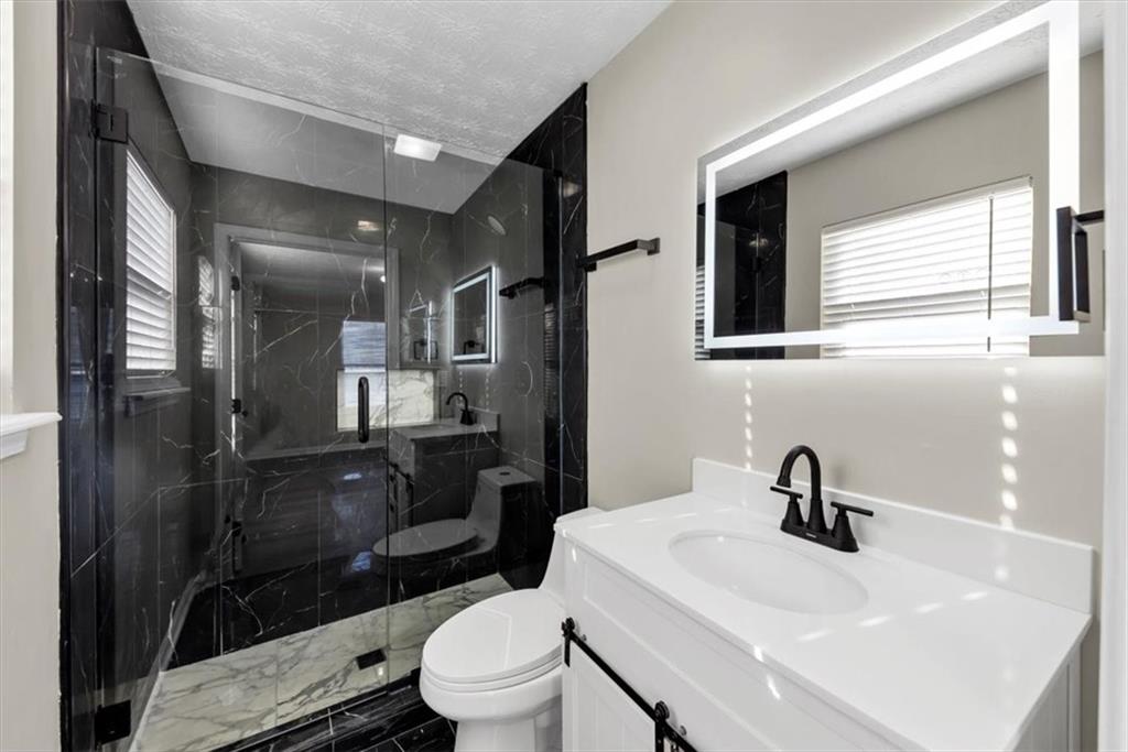2478 Verbena Circle Northwest Atlanta, GA 30314 - Photo 30 of 42 a bathroom with a sink toilet and shower