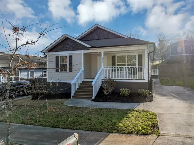 a front view of a house with a garden
