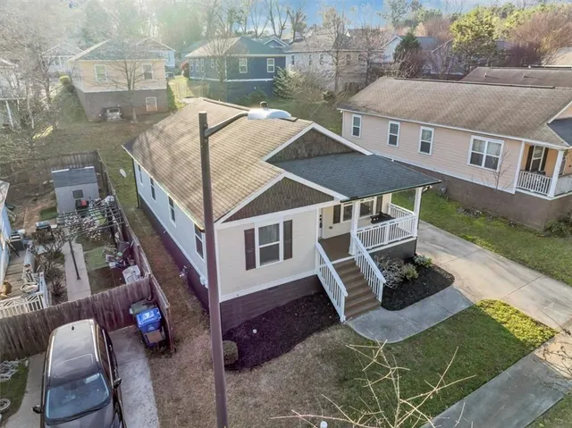 an aerial view of a house with backyard