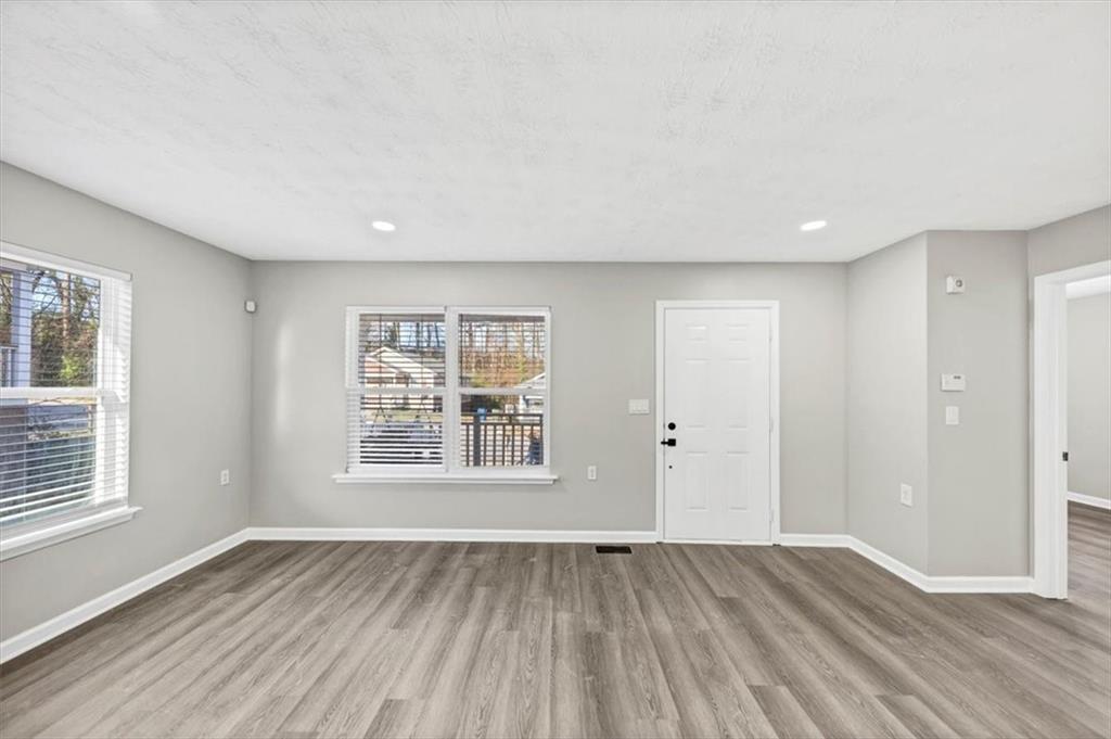 2478 Verbena Circle Northwest Atlanta, GA 30314 - Photo 4 of 42 an empty room with wooden floor and windows