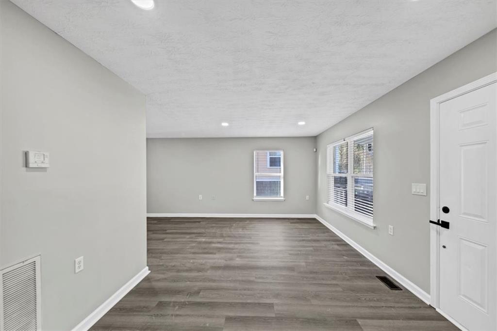 2478 Verbena Circle Northwest Atlanta, GA 30314 - Photo 5 of 42 a view of an empty room with a window and wooden floor