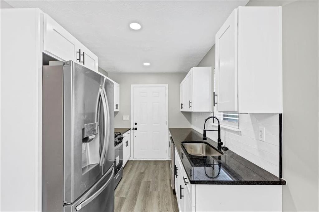 2478 Verbena Circle Northwest Atlanta, GA 30314 - Photo 10 of 42 a kitchen with stainless steel appliances granite countertop a sink stove and refrigerator