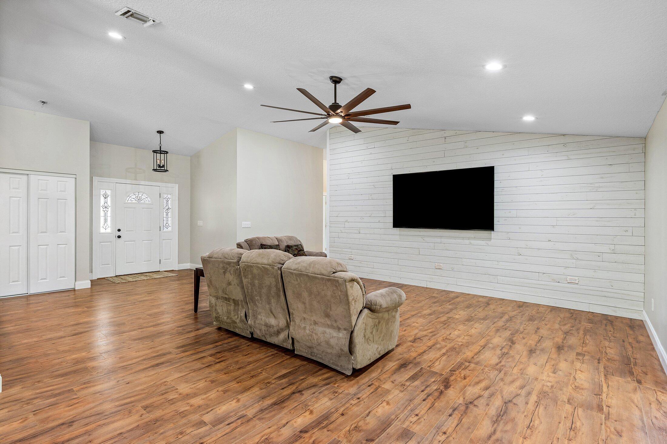 18142 43rd Road North Loxahatchee, FL 33470 - Photo 12 of 42 a living room with furniture and a flat screen tv