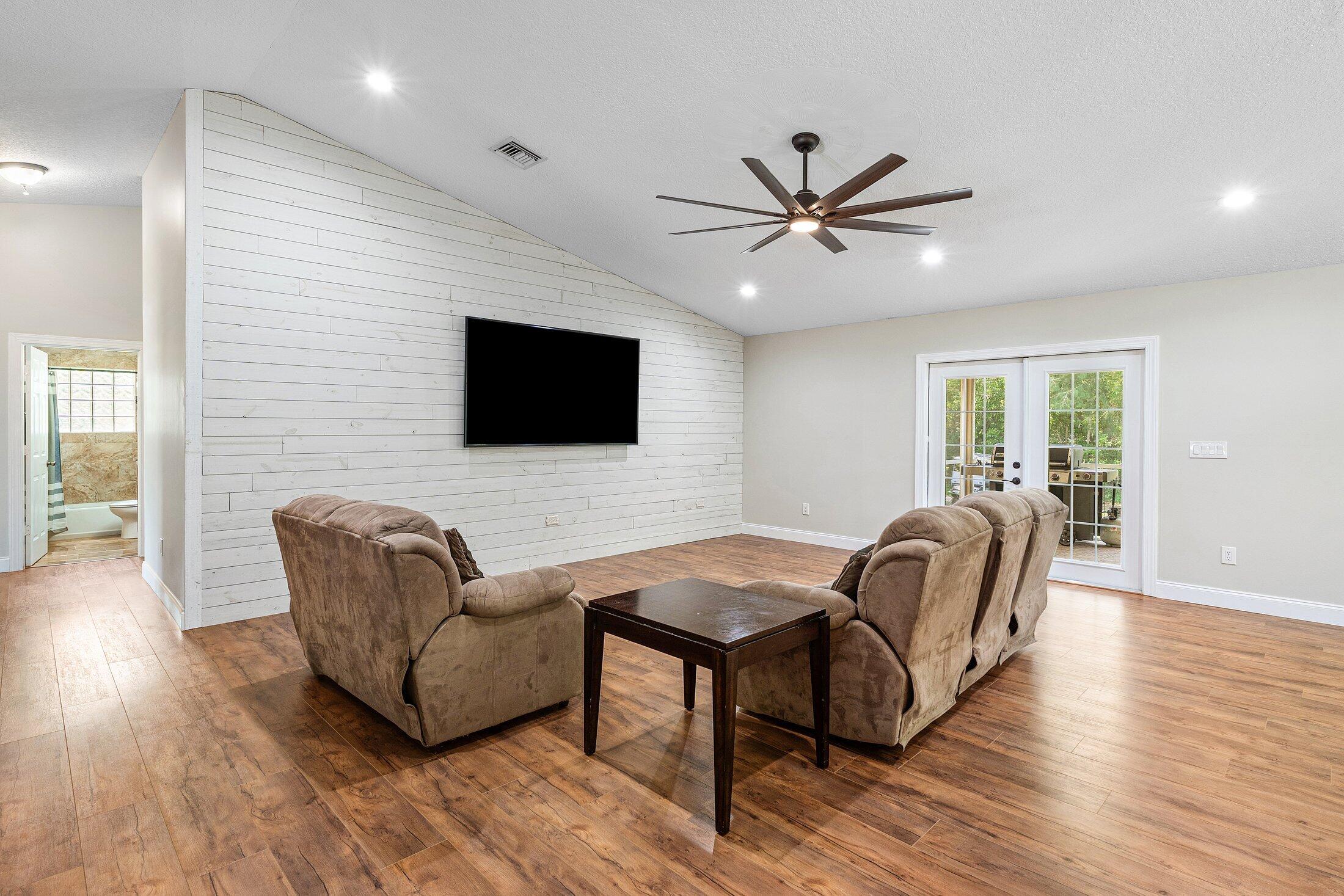 18142 43rd Road North Loxahatchee, FL 33470 - Photo 13 of 42 a living room with furniture and a flat screen tv