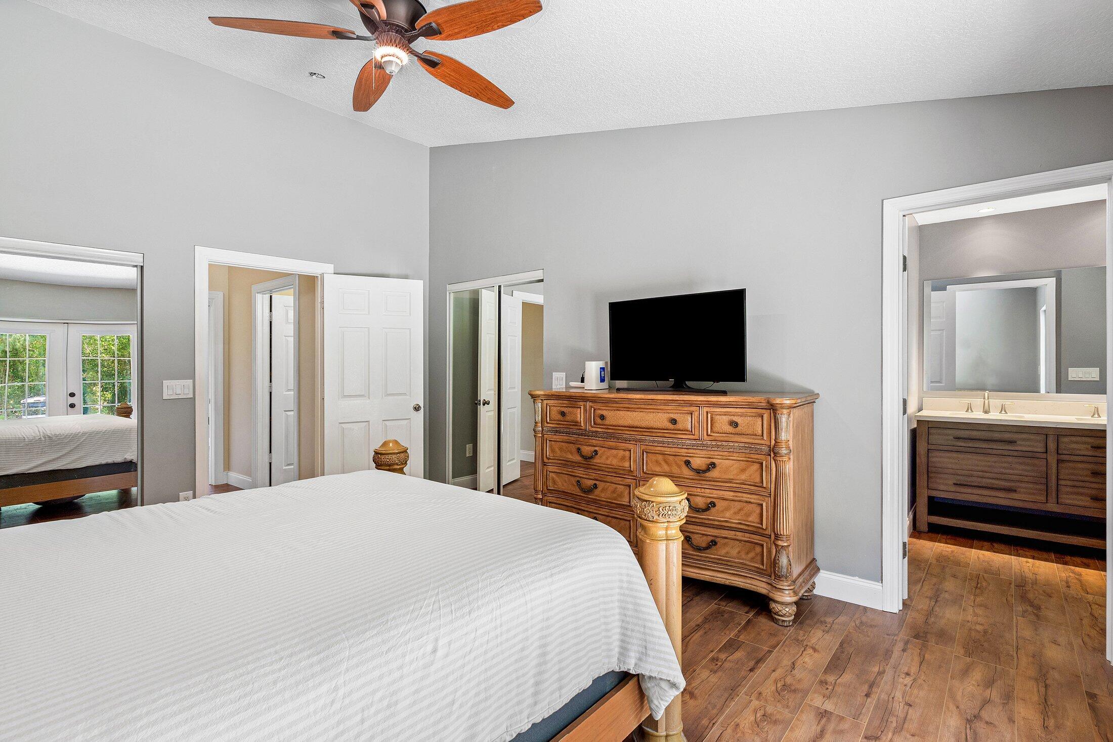 18142 43rd Road North Loxahatchee, FL 33470 - Photo 15 of 42 a bedroom with a bed and a flat tv screen on wall