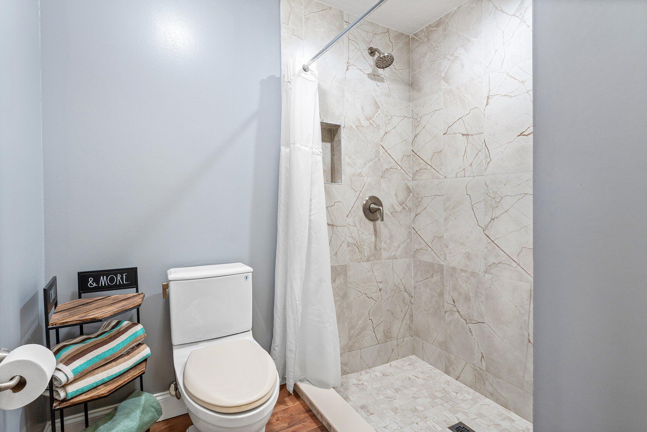 18142 43rd Road North Loxahatchee, FL 33470 - Photo 18 of 42 a white toilet sitting next to a bathroom sink