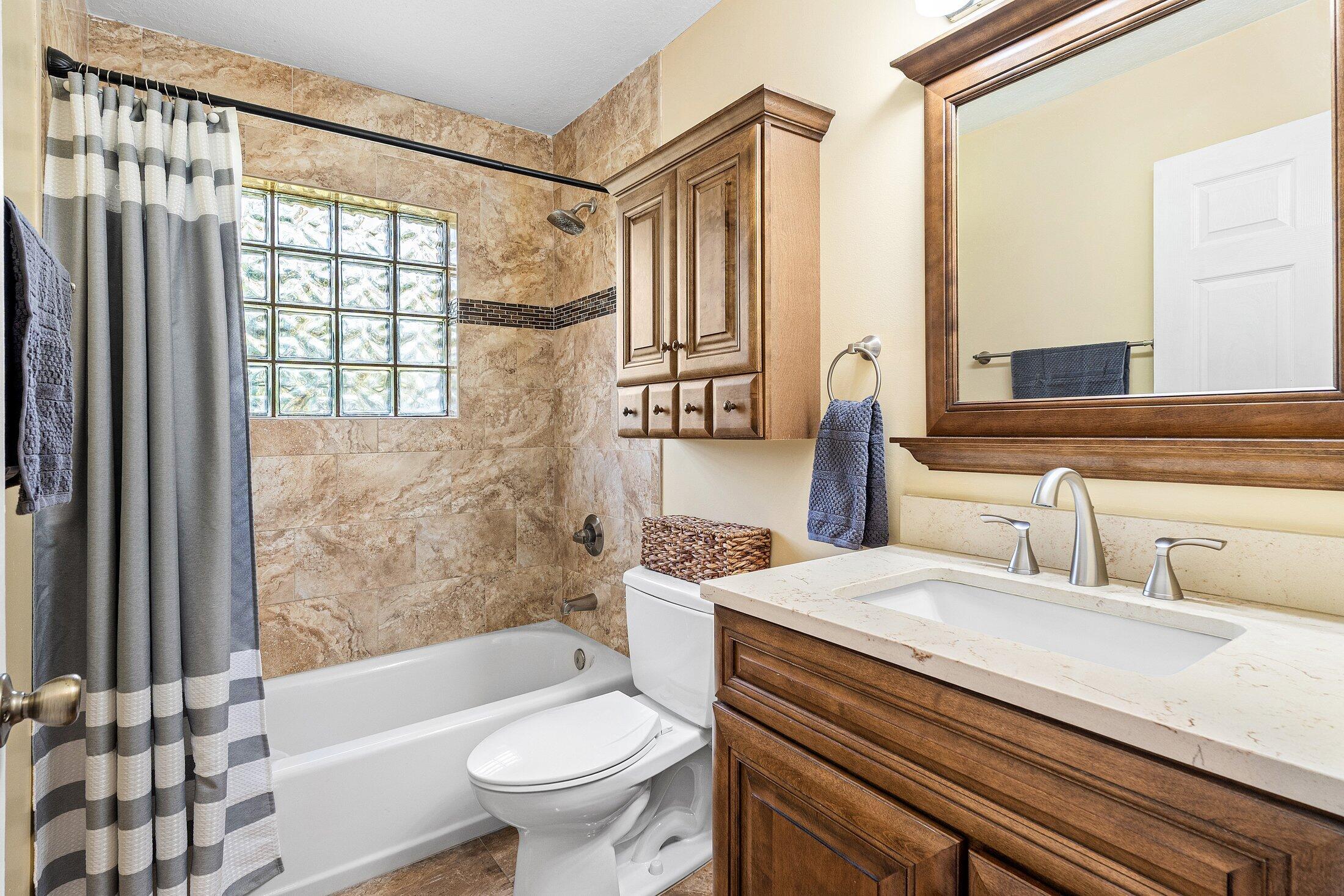 18142 43rd Road North Loxahatchee, FL 33470 - Photo 21 of 42 a bathroom with a sink a toilet a mirror and shower