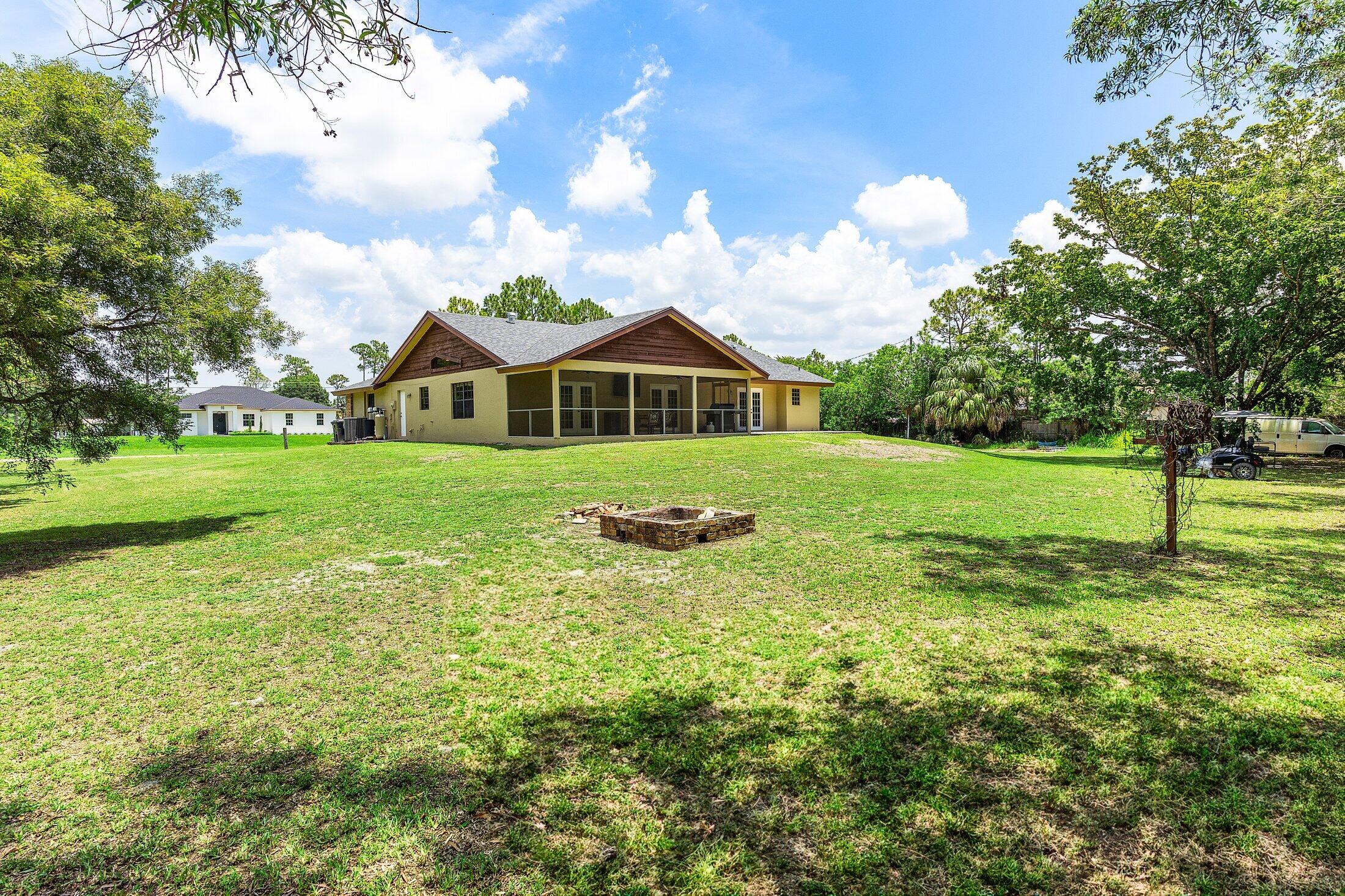 18142 43rd Road North Loxahatchee, FL 33470 - Photo 28 of 42 a front view of a house with a yard