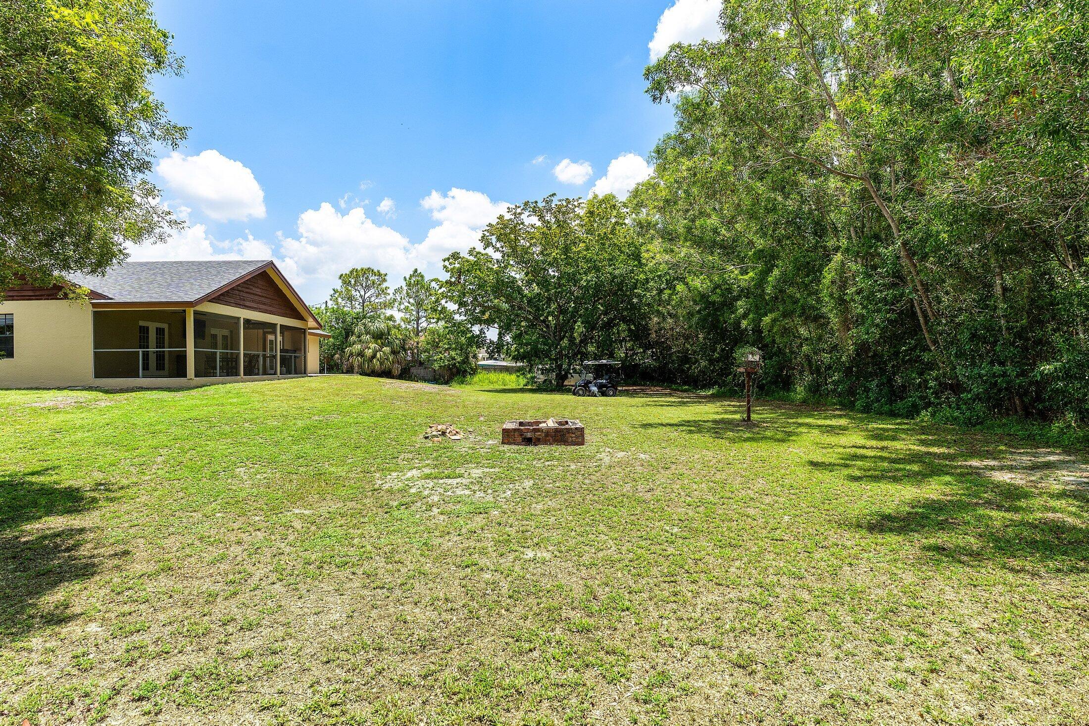 18142 43rd Road North Loxahatchee, FL 33470 - Photo 29 of 42 a view of a house with pool and a yard