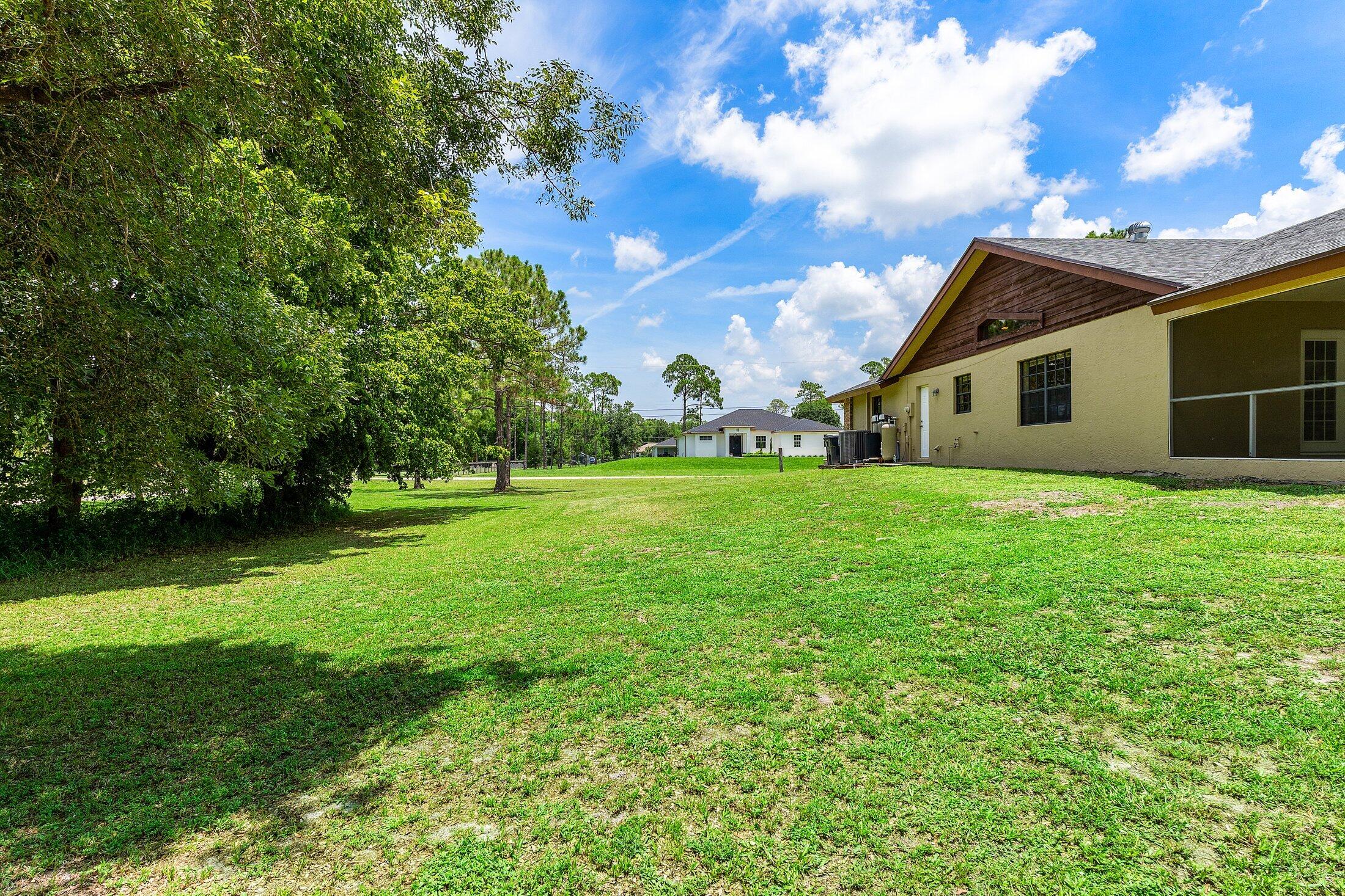 18142 43rd Road North Loxahatchee, FL 33470 - Photo 30 of 42 a house view with garden space