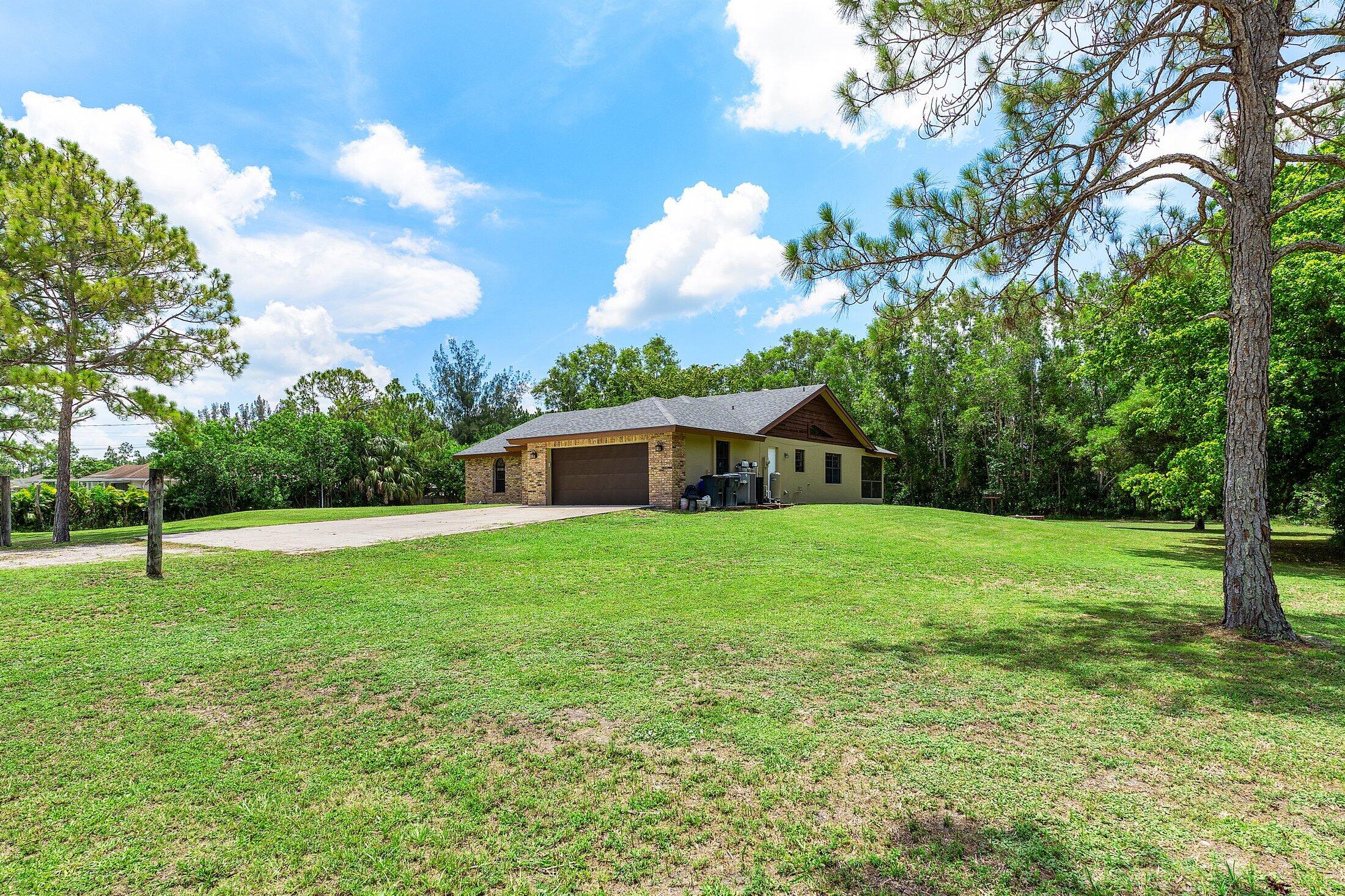 18142 43rd Road North Loxahatchee, FL 33470 - Photo 32 of 42 a view of a house with a backyard