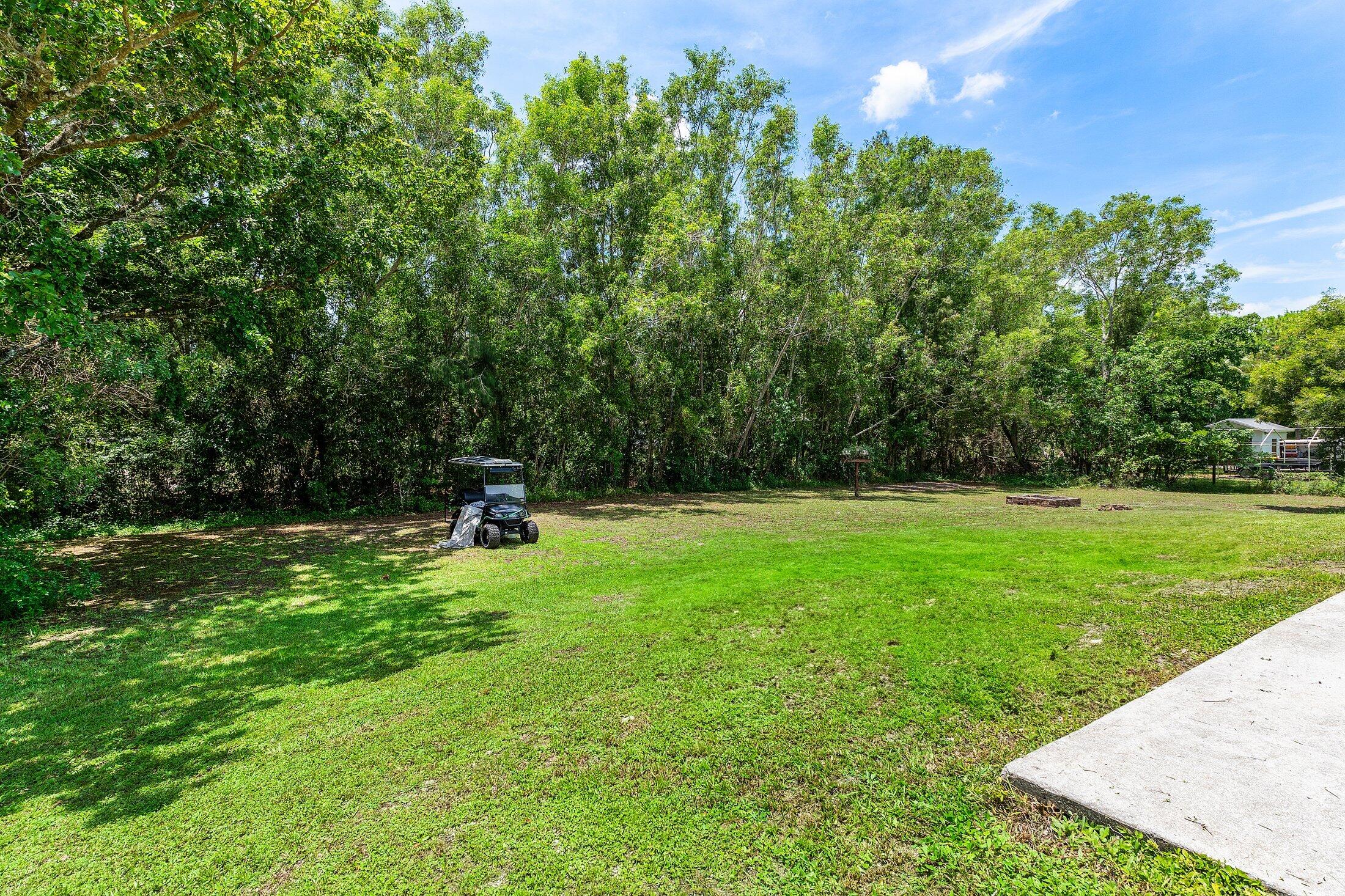 18142 43rd Road North Loxahatchee, FL 33470 - Photo 34 of 42 a house view with a garden space