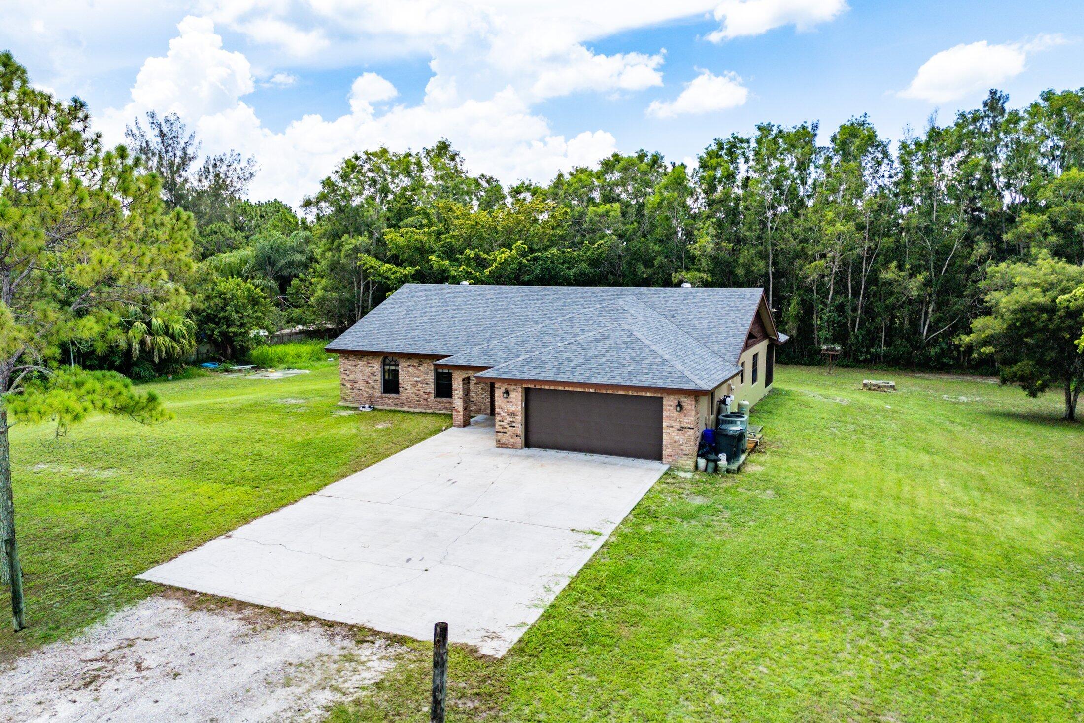18142 43rd Road North Loxahatchee, FL 33470 - Photo 36 of 42 a aerial view of a house next to a big yard