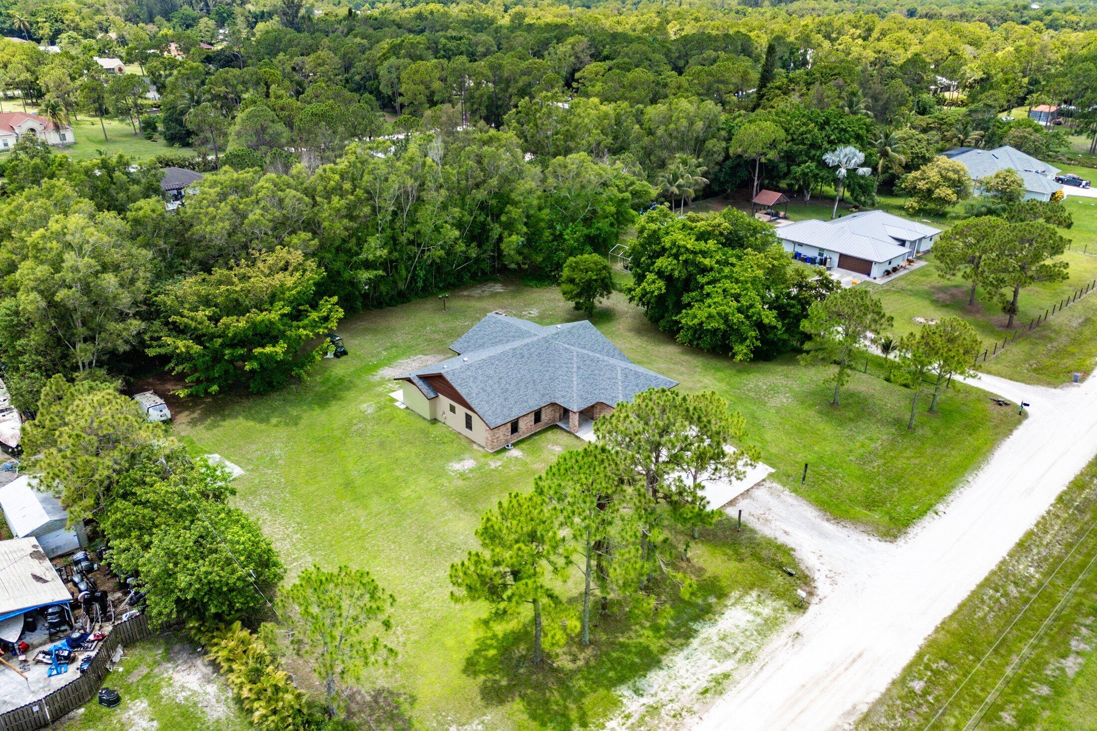 18142 43rd Road North Loxahatchee, FL 33470 - Photo 37 of 42 an aerial view of a house with a yard and lake view