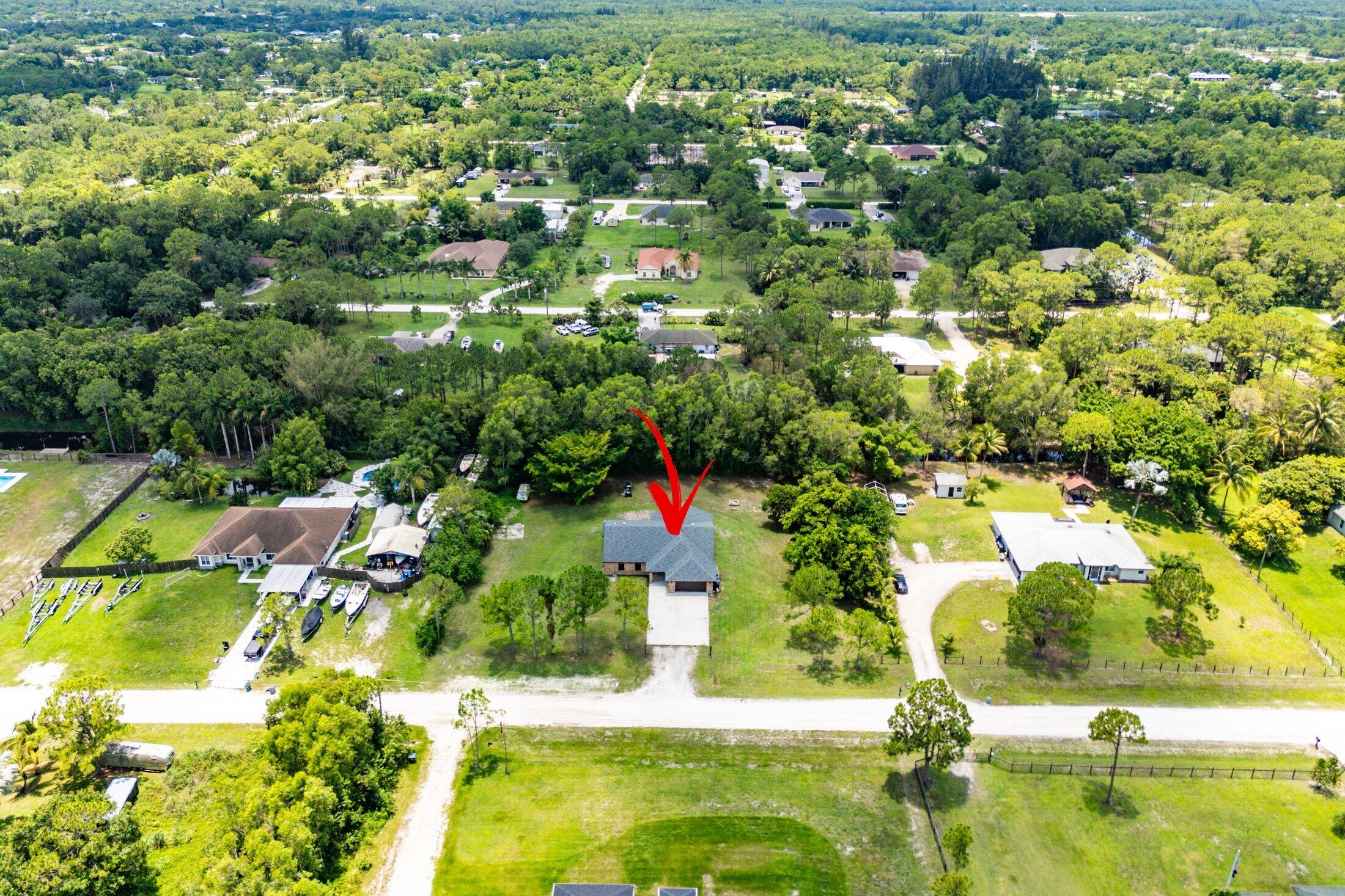 18142 43rd Road North Loxahatchee, FL 33470 - Photo 38 of 42 an aerial view of residential houses with outdoor space and trees all around
