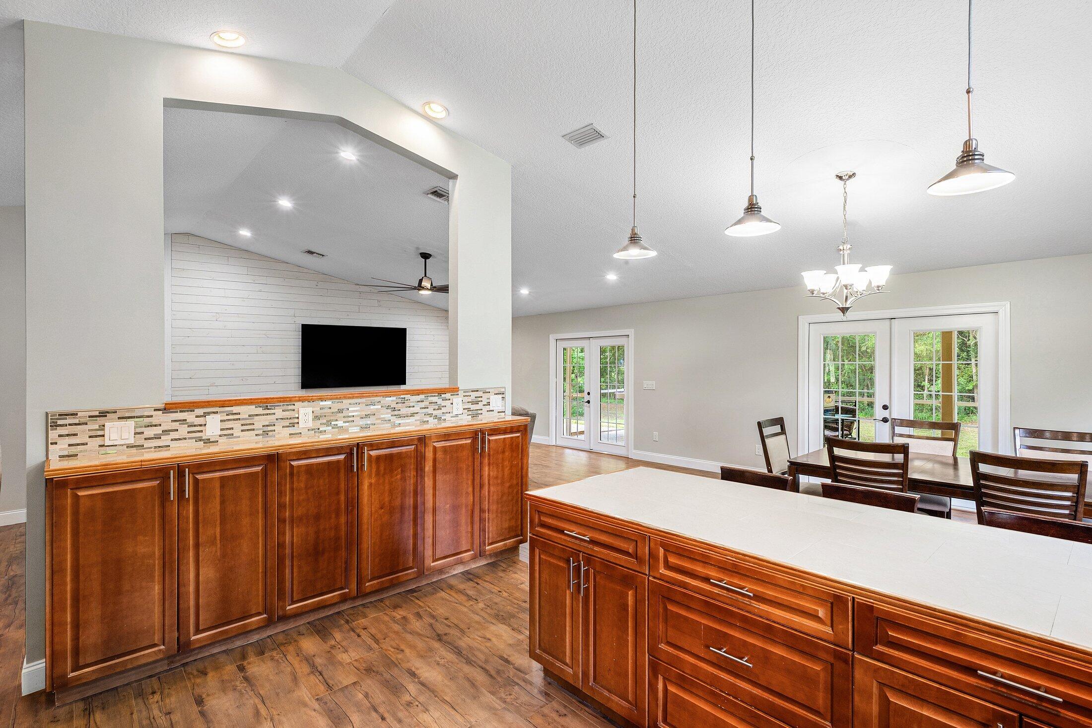 18142 43rd Road North Loxahatchee, FL 33470 - Photo 8 of 42 a large kitchen with kitchen island a large island in it