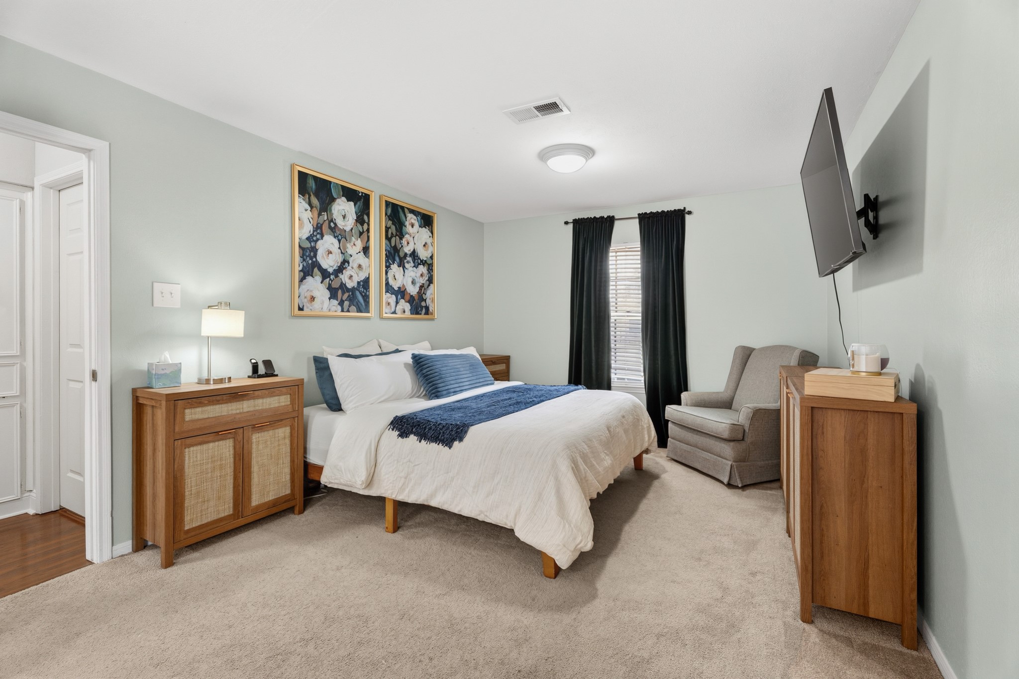 2104 Rose Road Pearland, TX 77581 - Photo 34 of 43 a spacious bedroom with a bed and a flat screen tv