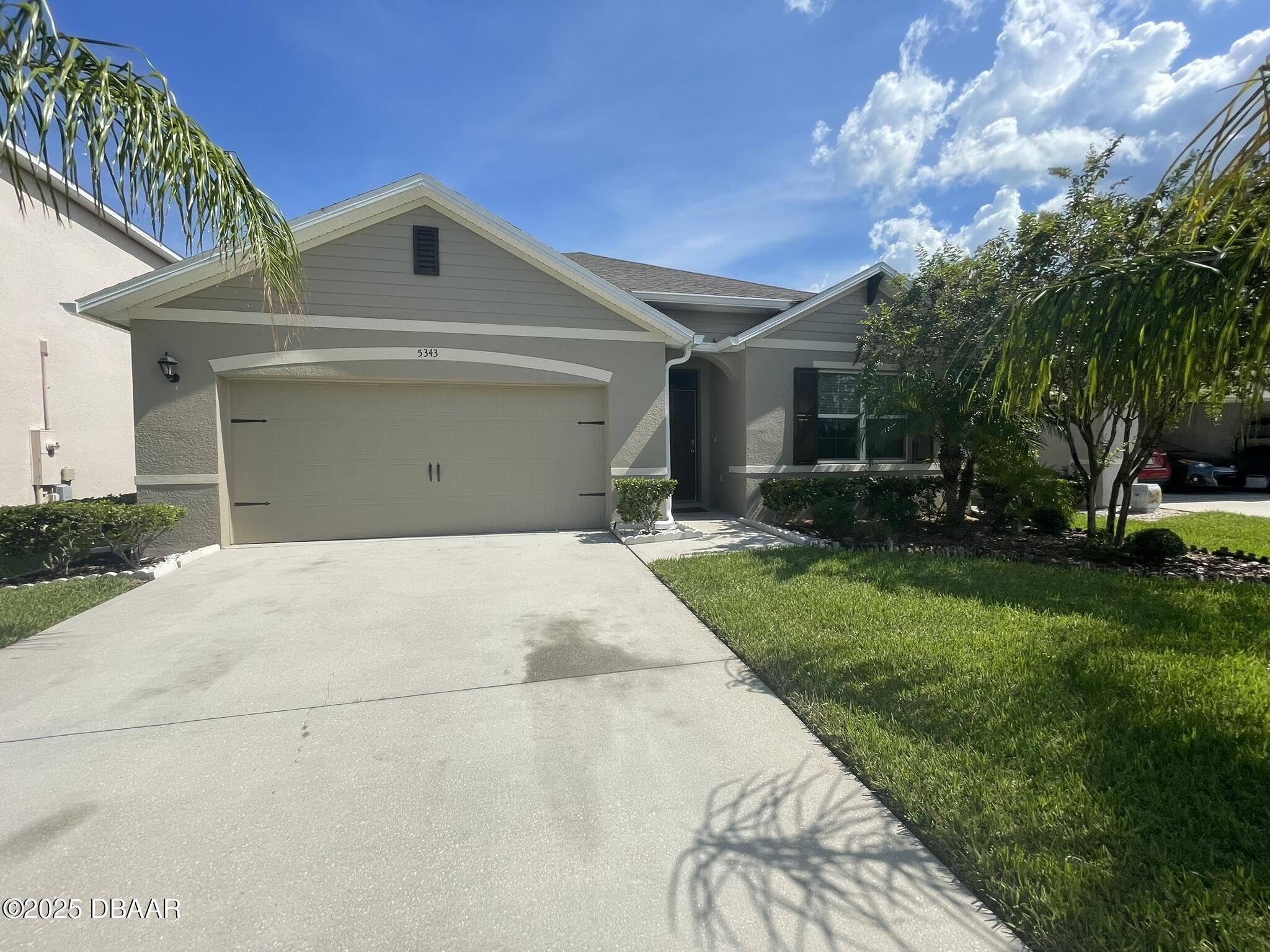 5343 Sandpine Haven Lane Port Orange, FL 32128 - Photo 1 of 44 a front view of a house with a yard and garage
