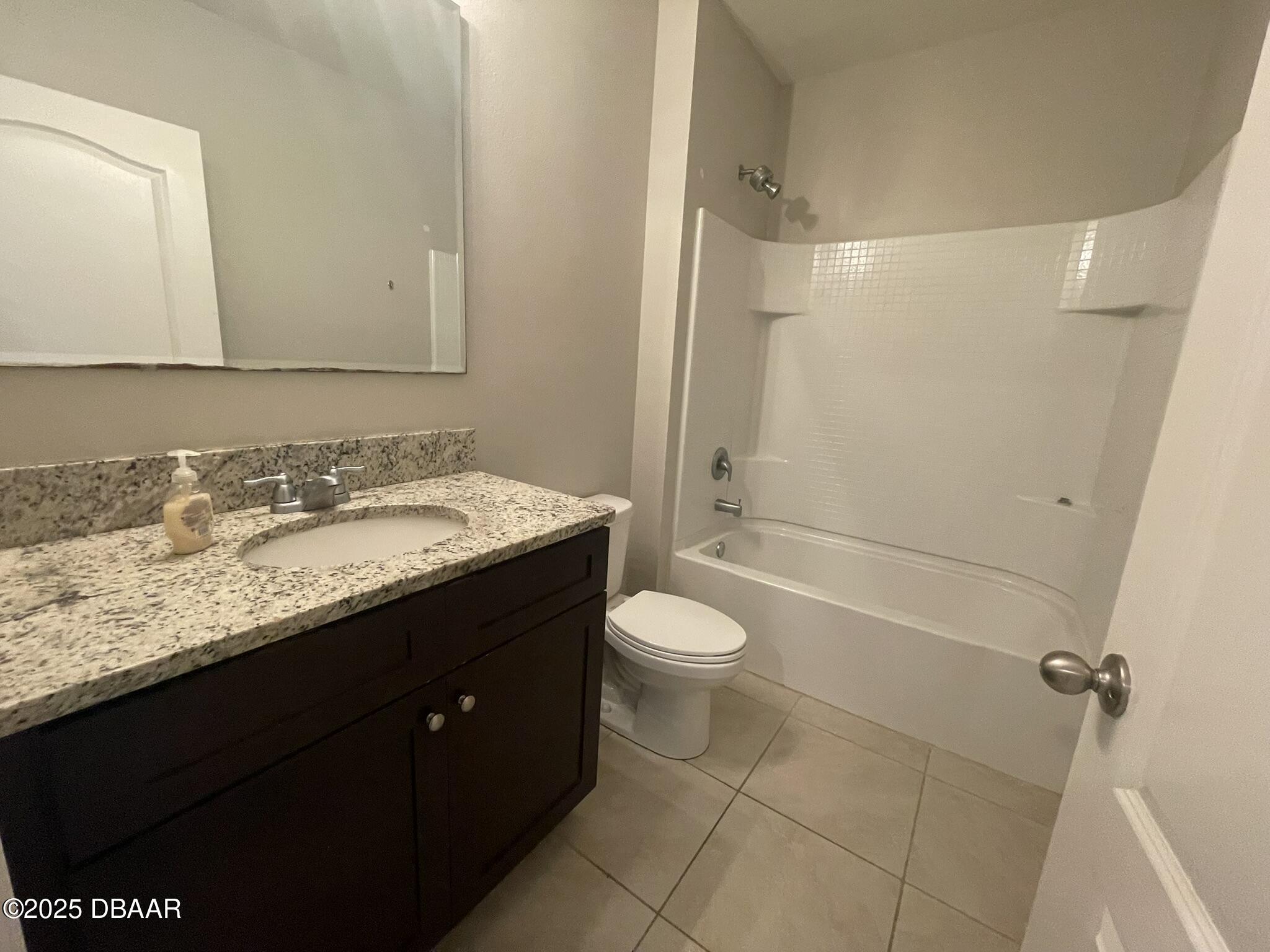 5343 Sandpine Haven Lane Port Orange, FL 32128 - Photo 12 of 44 a bathroom with a granite countertop sink toilet and shower