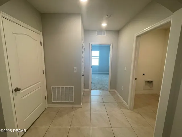 an empty room with windows and chandelier