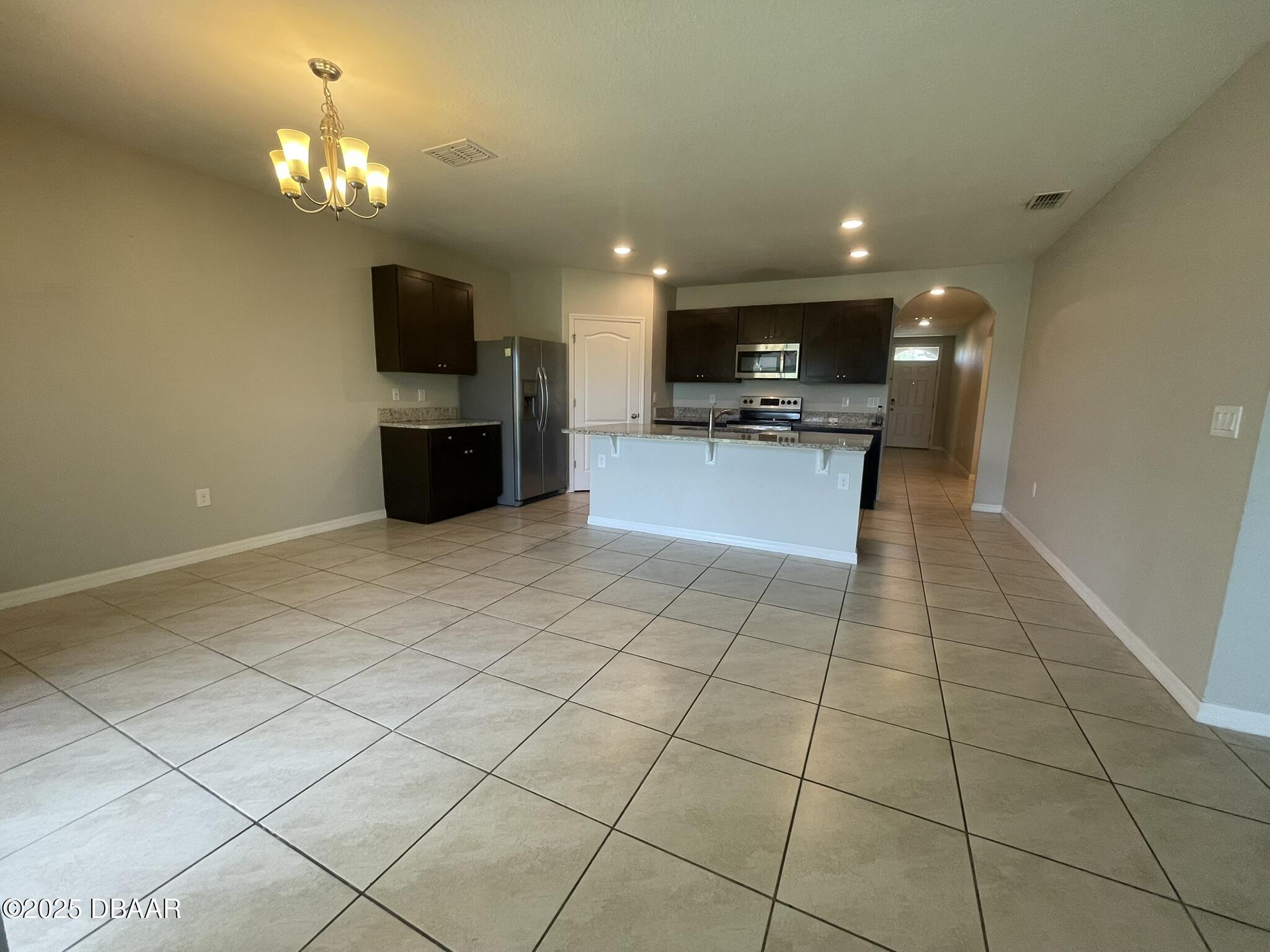 5343 Sandpine Haven Lane Port Orange, FL 32128 - Photo 21 of 44 a view of kitchen with microwave cabinets and refrigerator
