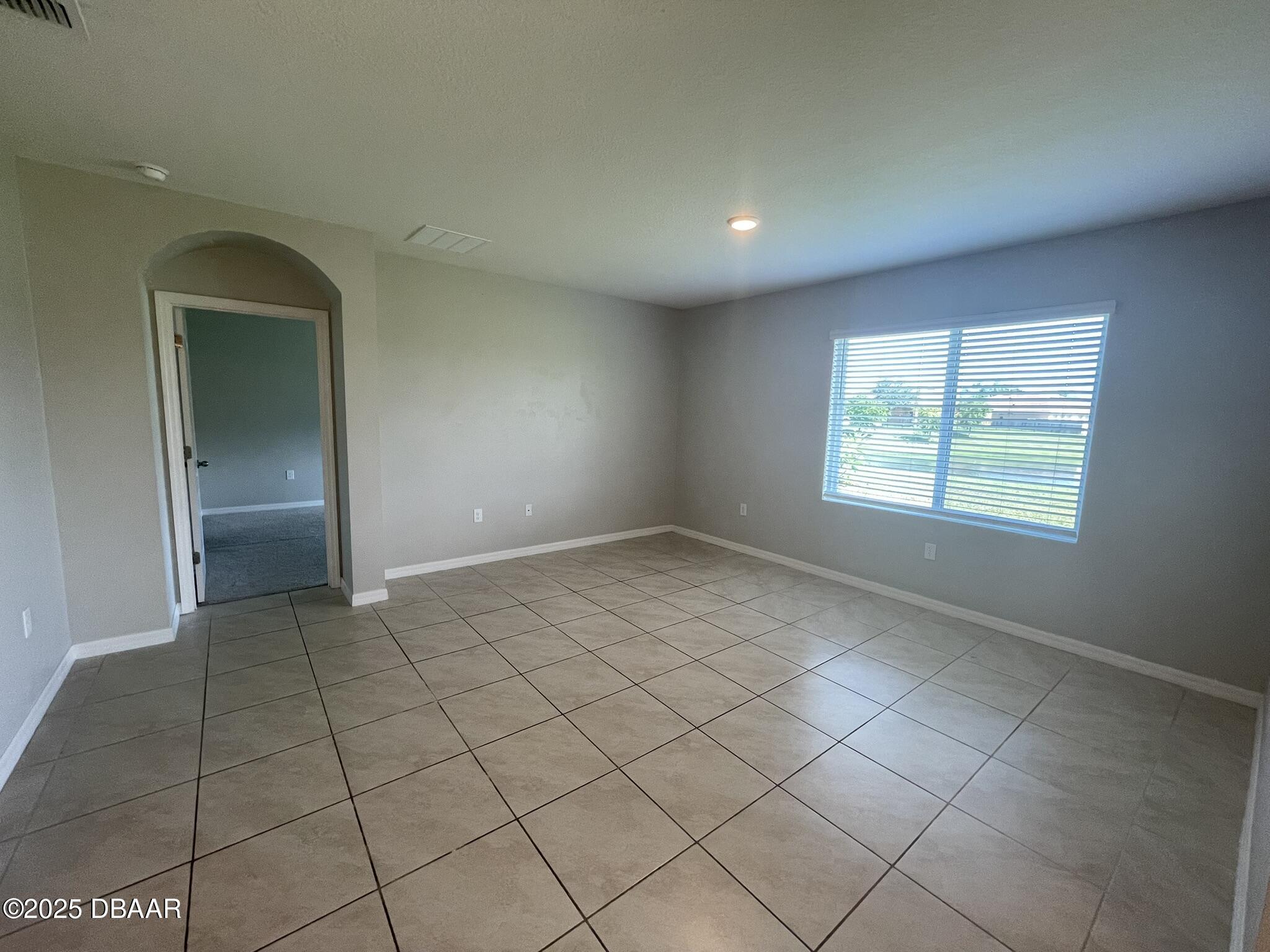 5343 Sandpine Haven Lane Port Orange, FL 32128 - Photo 24 of 44 an empty room with windows and chandelier
