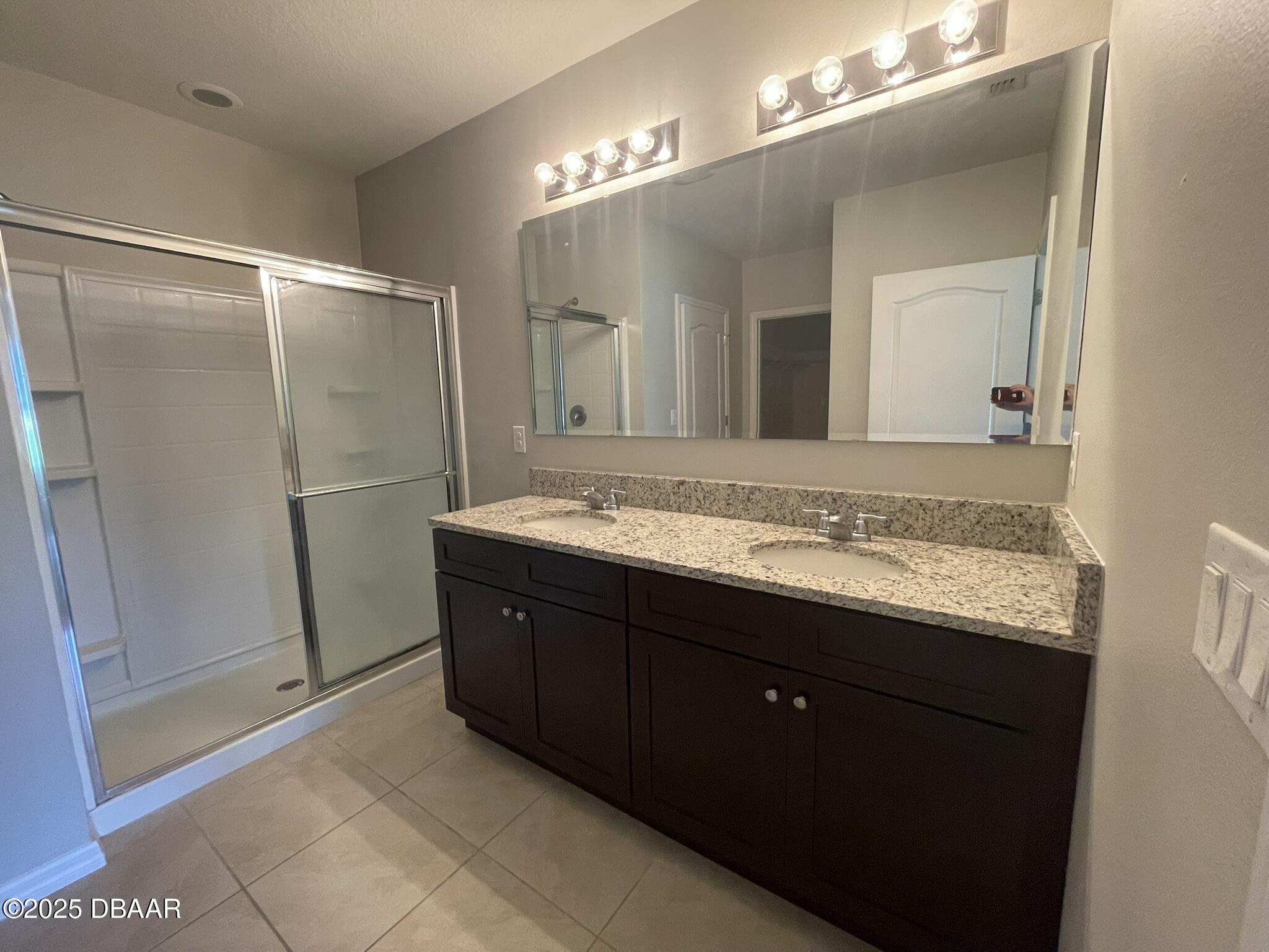 5343 Sandpine Haven Lane Port Orange, FL 32128 - Photo 28 of 44 a bathroom with a granite countertop sink mirror and a shower