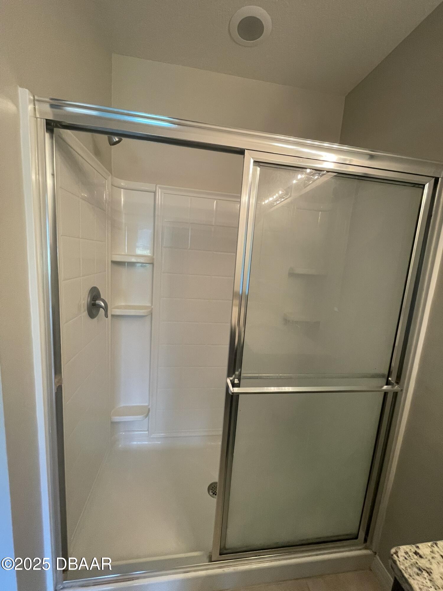 5343 Sandpine Haven Lane Port Orange, FL 32128 - Photo 30 of 44 a bathroom with a glass shower door