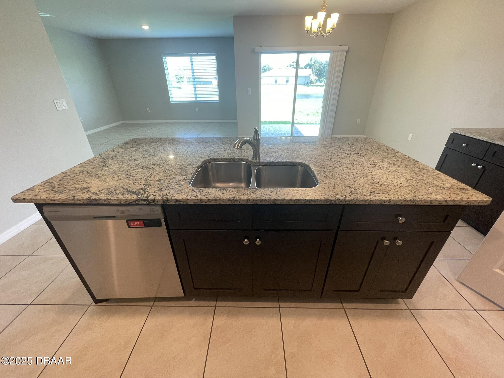 5343 Sandpine Haven Lane Port Orange, FL 32128 - Photo 3 of 44 a kitchen with granite countertop a sink a counter top space and cabinets