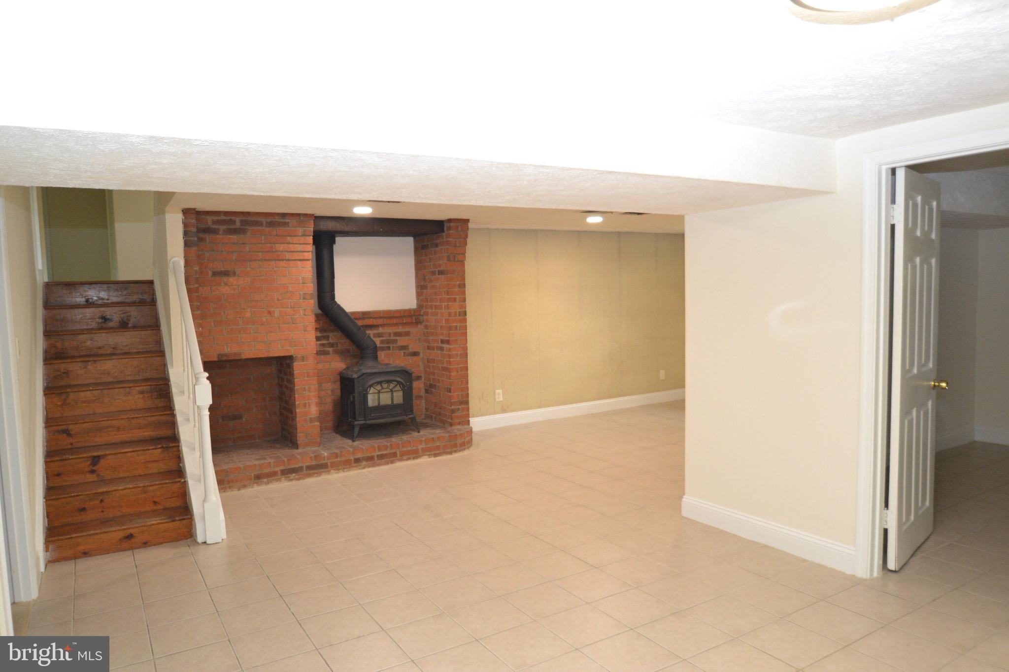 1600 Chain Bridge Road McLean, VA 22101 - Photo 29 of 35 Basement Rec Room with wood stove