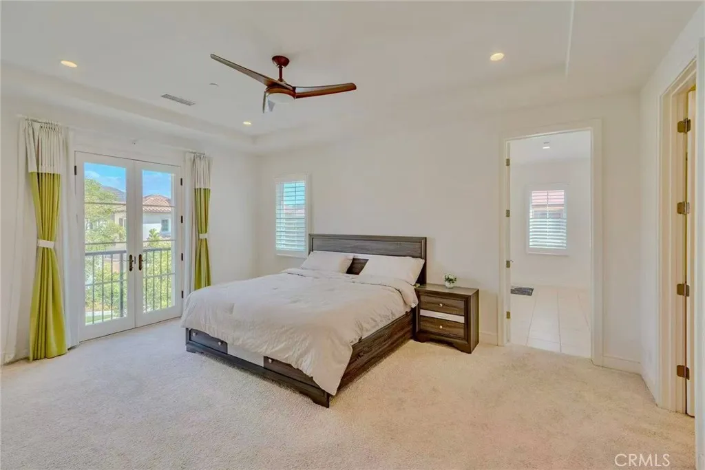 141 Dolci Irvine, CA 92606 - Photo 12 of 13 a bed sitting in a spacious bedroom next to a window