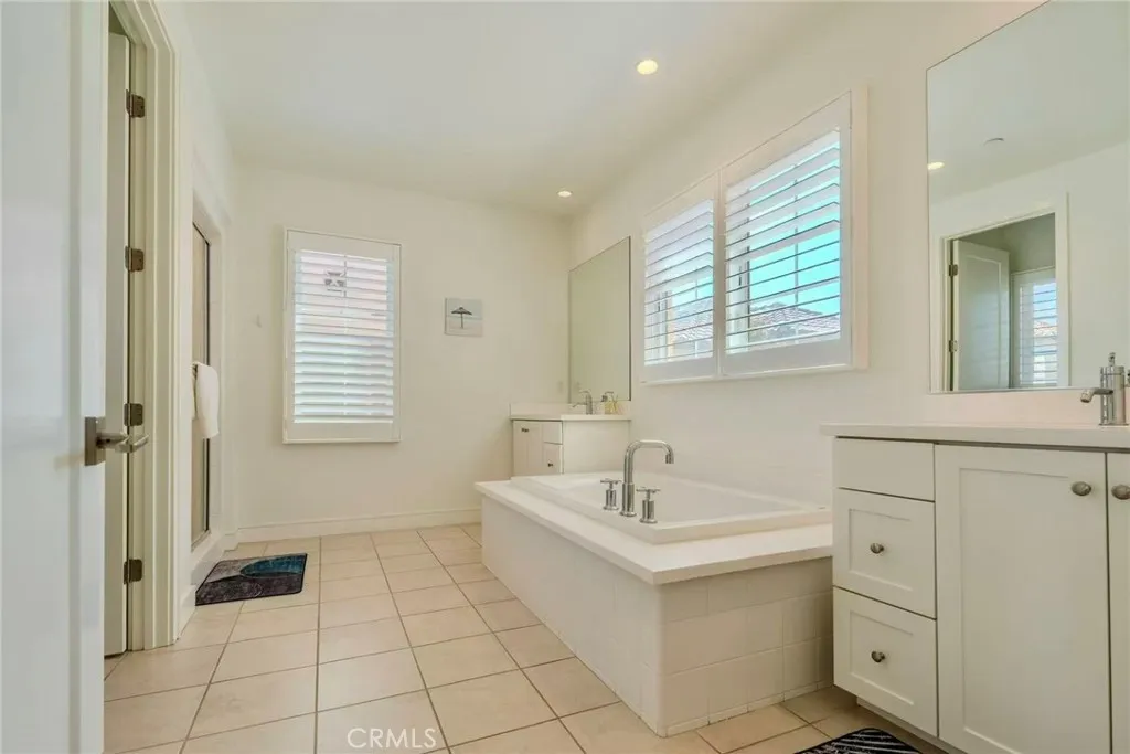 141 Dolci Irvine, CA 92606 - Photo 4 of 13 a bathroom with a sink a mirror and a bathtub
