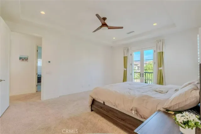 a living room with furniture potted plant and kitchen view