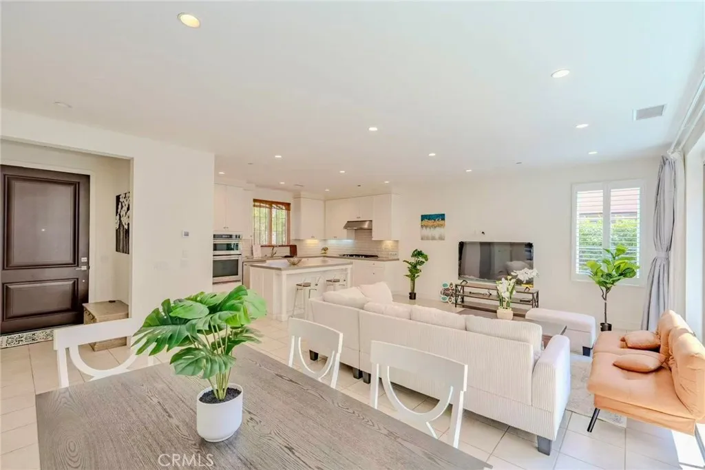 141 Dolci Irvine, CA 92606 - Photo 8 of 13 a living room with furniture potted plant and kitchen view