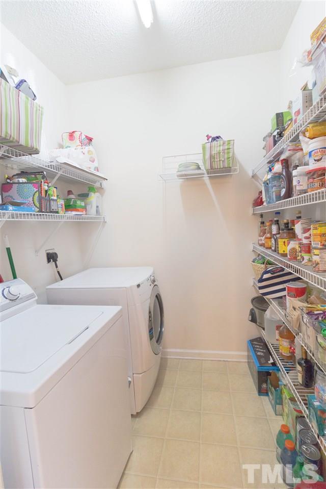1011 Dual Parks Road Apex, NC 27502 - Photo 15 of 21 Fantastic laundry room with plenty of space for washer/dryer and pantry.