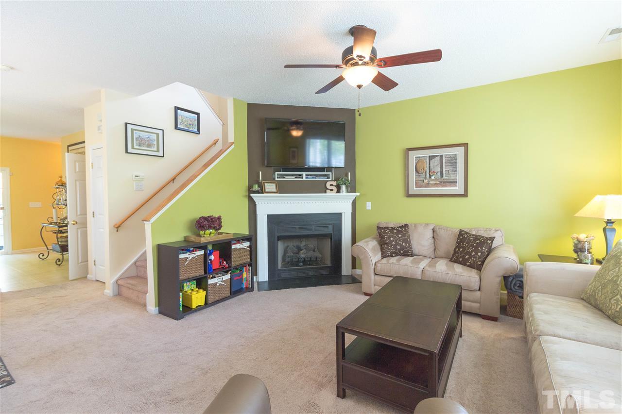 1011 Dual Parks Road Apex, NC 27502 - Photo 3 of 21 Living room has corner gas-log fireplace with slate surround and hearth.