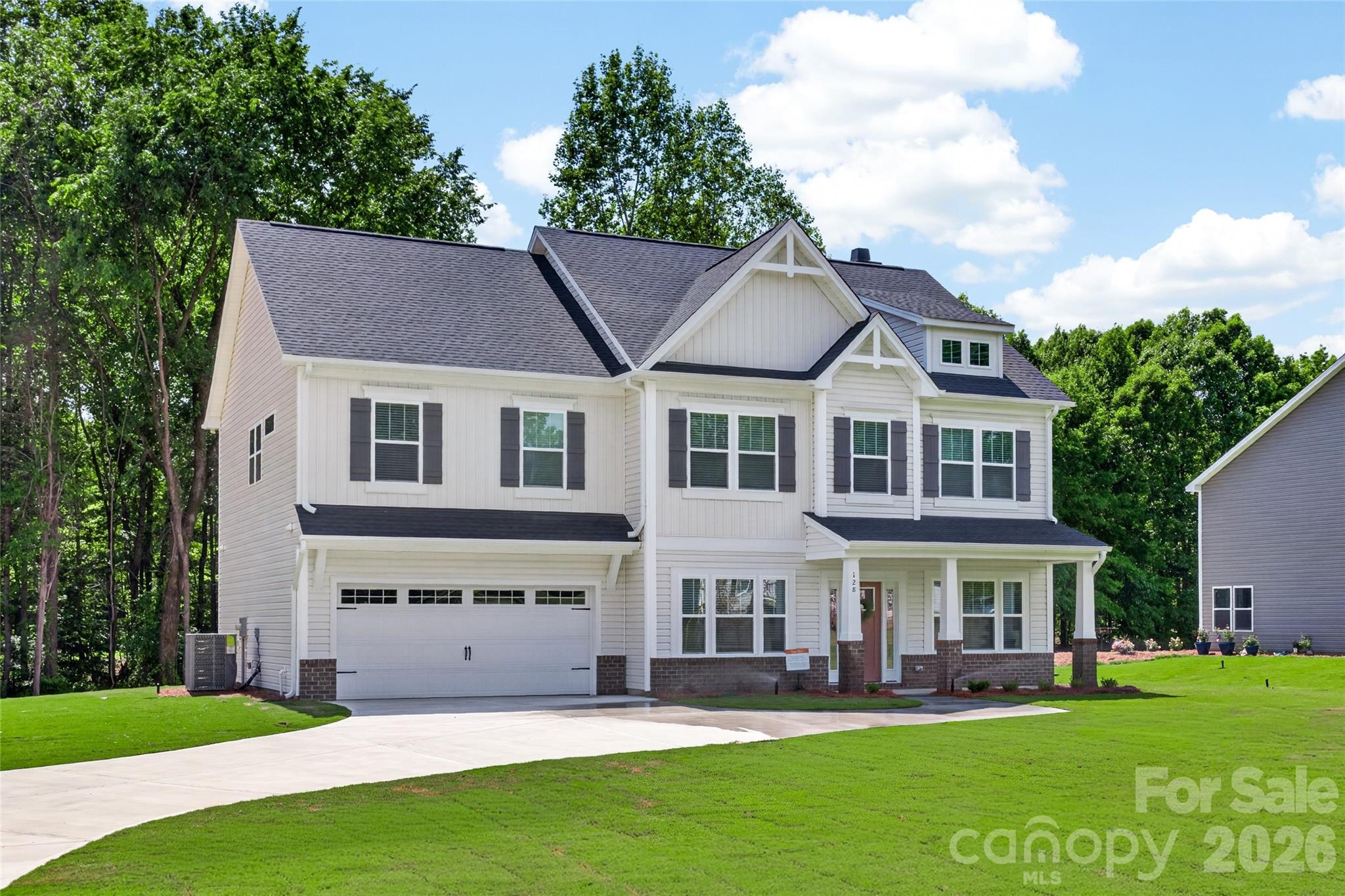 128 Overcash Road, Unit 7171 Troutman, NC 28166 - Photo 1 of 41 a big white house with a yard and plants