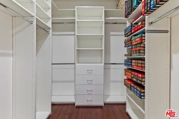 a view of walk in closet with empty racks