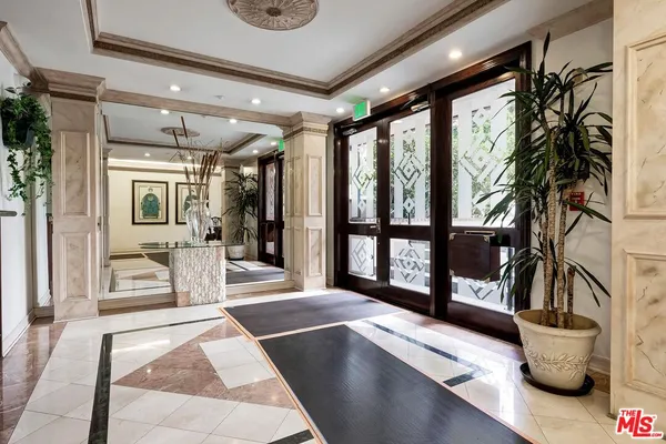 a front view of a residential apartment building with a yard