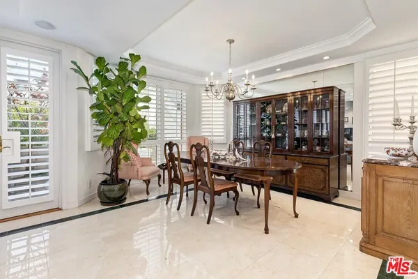 a view of a dining room with furniture and chandelier
