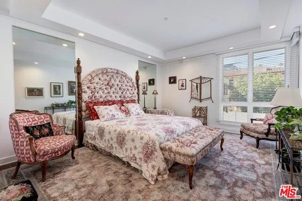 a bedroom with a large bed and a balcony