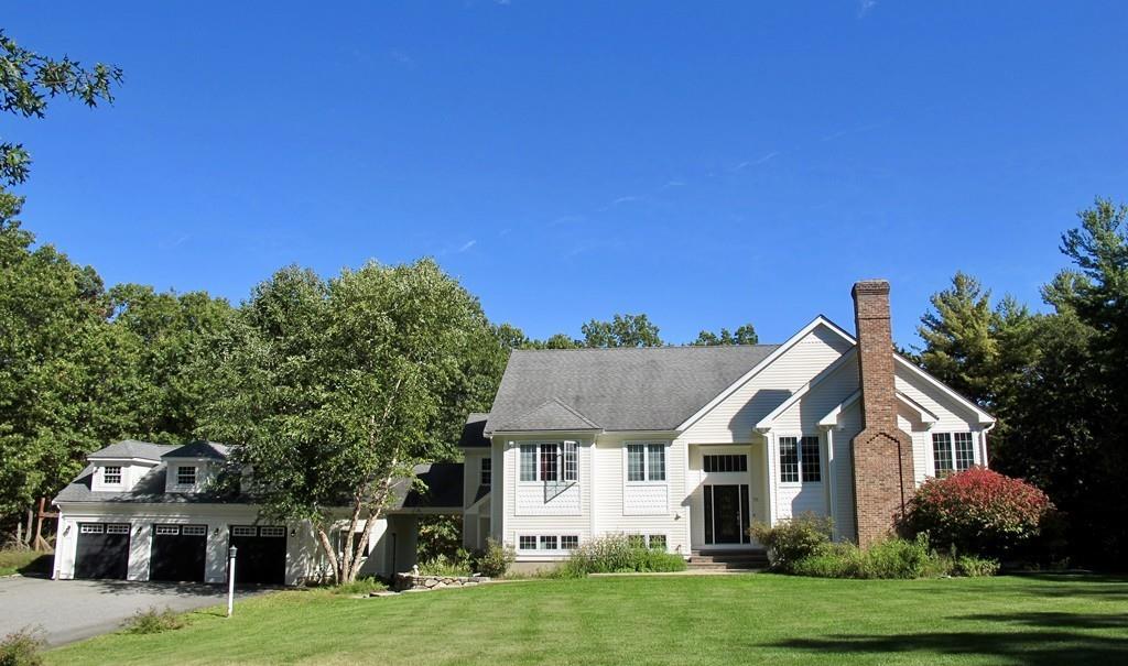 32 Frye Road Bolton, MA 01740 - Photo 1 of 35 a front view of a house with a garden