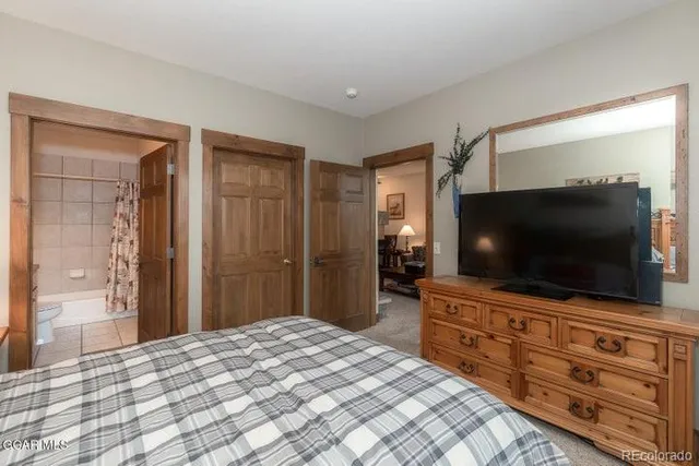 a bedroom with a bed and a flat screen tv in it
