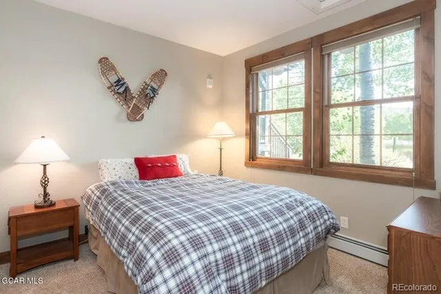 a bedroom with a large bed and a window