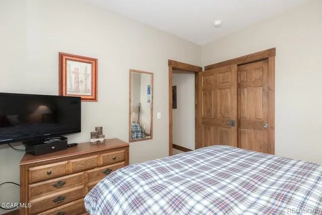 a bedroom with a bed and a flat screen tv