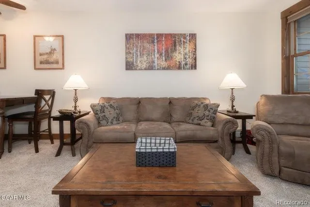 a living room with furniture and a lamp